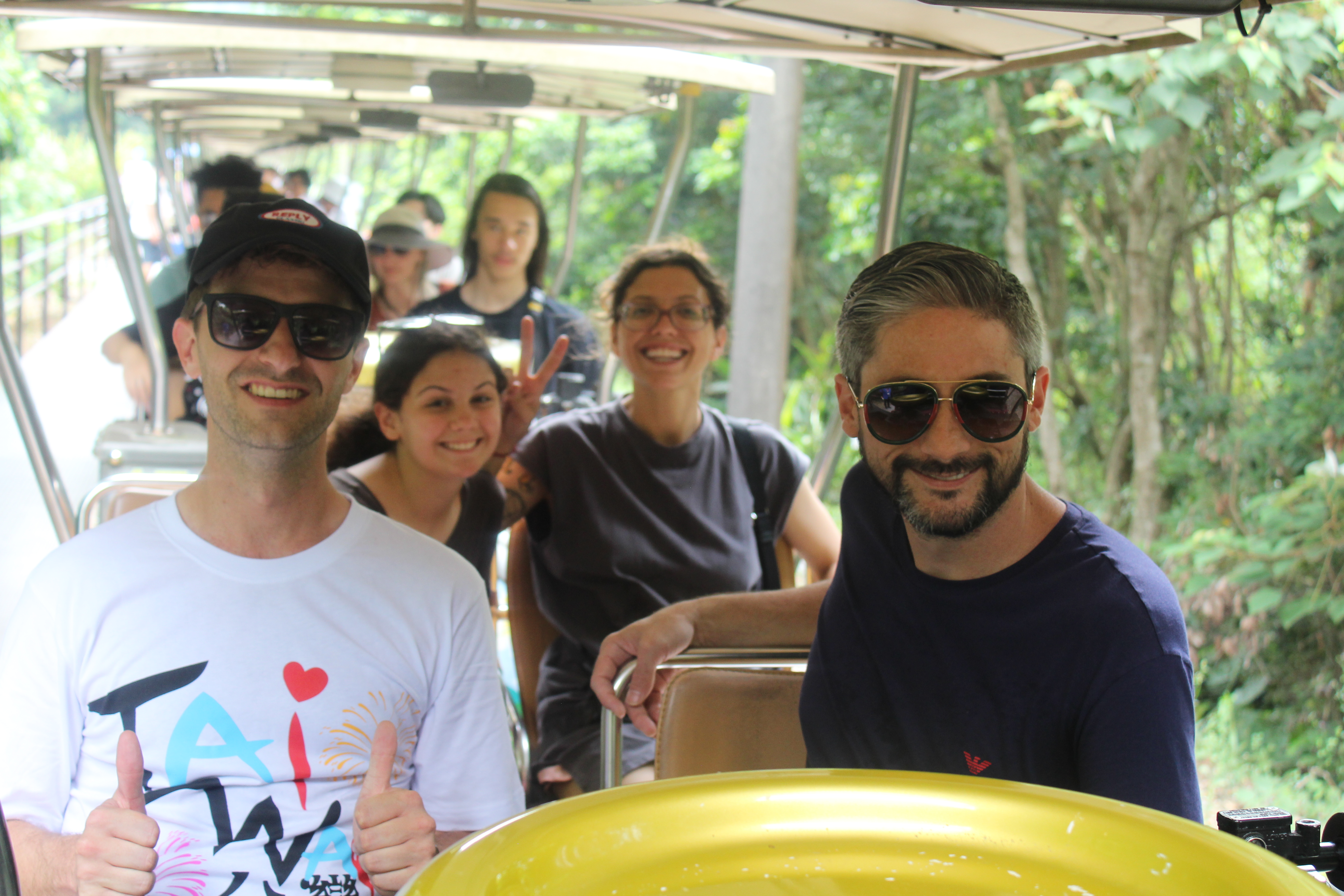 MLC students enjoying a tram ride through lush greenery in Taiwan
